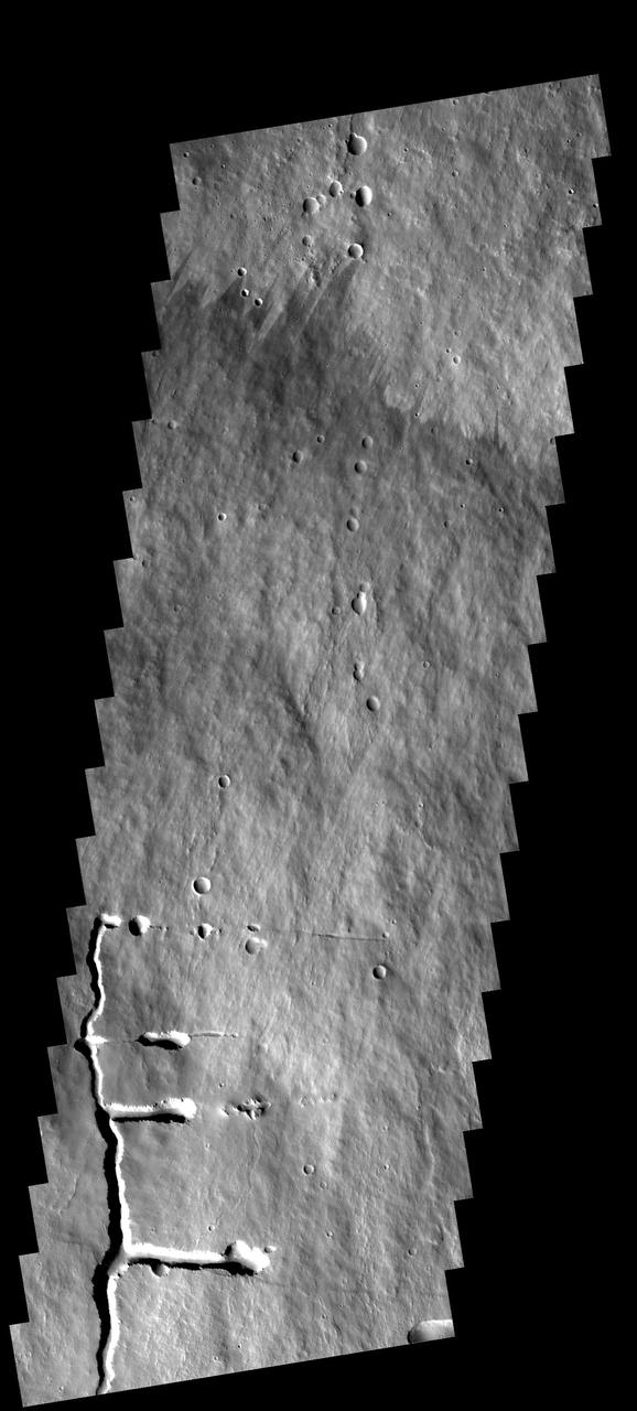 This image shows a portion of the flank of Pavonis Mons as seen by NASA 2001 Mars Odyssey spacecraft. The collapse features at the bottom of the image are related to subsurface tubes that once contained lava.