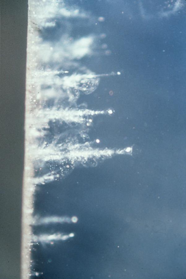 In an experiment using a special air gun, particles are shot into aerogel at high velocities. Closeup of particles leaving a carrot-shaped trail in the aerogel are shown here. Aerogel was used on NASA Stardust spacecraft.
