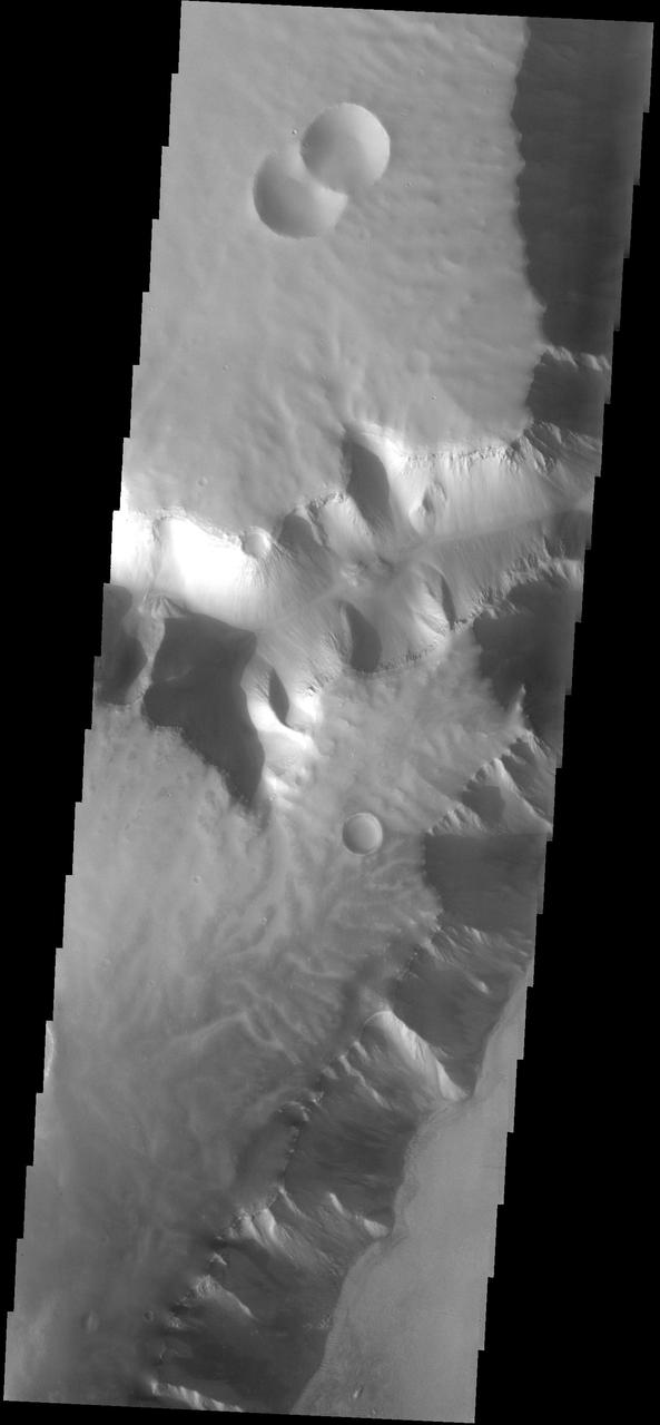 This plateau borders Echus Chasma. The surface of the plateau has been dissected by shallow channels of unknown origin. This image is from NASA 2001 Mars Odyssey spacecraft.