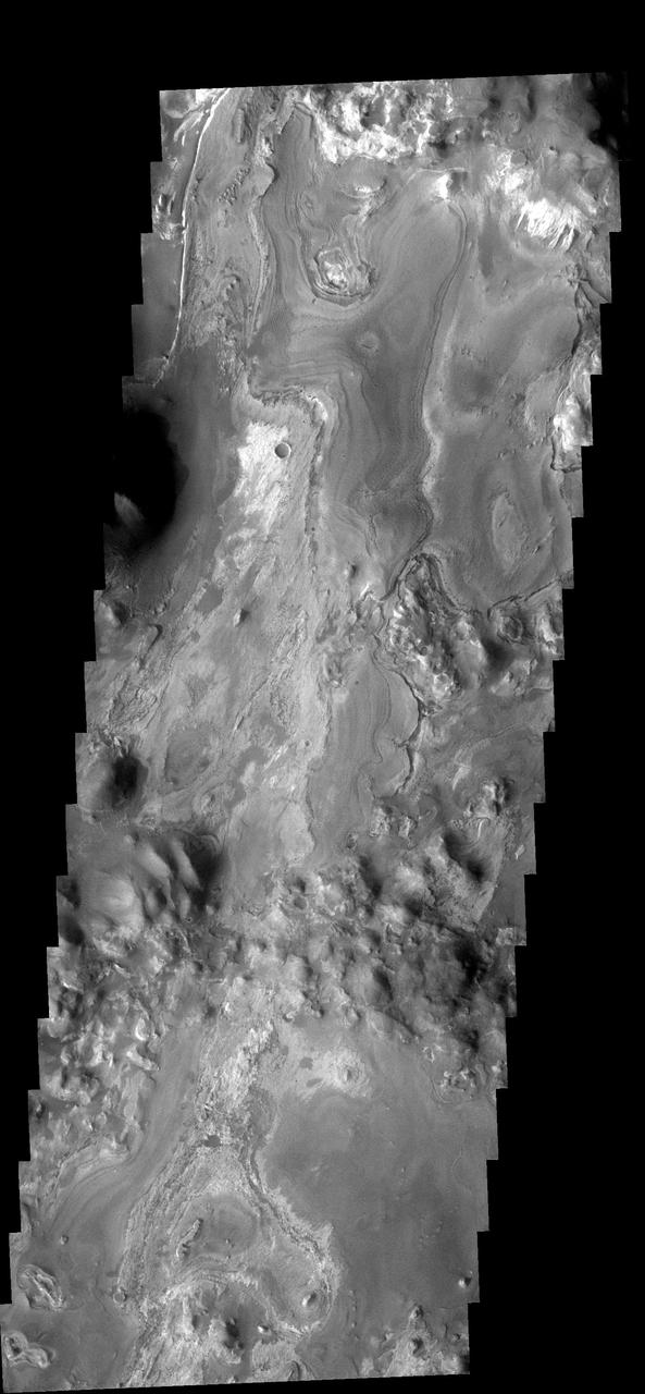 This VIS image captured by NASA 2001 Mars Odyssey spacecraft of Iani Chaos shows the layered deposit that occurs on the floor. It appears that the layers were deposited after the chaos was formed.  Image information: VIS instrument. Latitude 2.3S, Longitude 342.3E. 17 meter/pixel resolution.  http://photojournal.jpl.nasa.gov/catalog/PIA03200