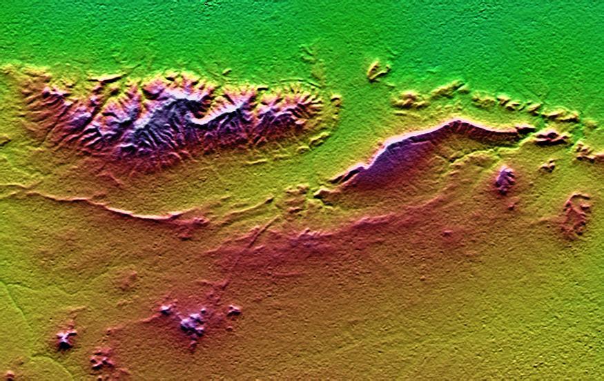 On January 26, 2001, the Kachchh region in western India suffered the most deadly earthquake in India's history. This shaded topography view of landforms northeast of the city of Bhuj depicts geologic structures that are of interest in the study the tectonic processes that may have led to that earthquake. However, preliminary field studies indicate that these structures are composed of Mesozoic rocks that are overlain by younger rocks showing little deformation. Thus these structures may be old, not actively growing, and not directly related to the recent earthquake.  The Haro Hills are on the left and the Kas Hills are on the right. The Haro Hills are an "anticline," which is an upwardly convex elongated fold of layered rocks. In this view, the anticline is distinctly ringed by an erosion resistant layer of sandstone. The east-west orientation of the anticline may relate to the crustal compression that has occurred during India's northward movement toward, and collision with, Asia. In contrast, the largest of the Kas Hills appears to be a tilted (to the south) and faulted (on the north) block of layered rocks. Also seen here, the linear feature trending toward the southwest from the image center is an erosion-resistant "dike," which is an igneous intrusion into older "host" rocks along a fault plane or other crack. These features are simple examples of how shaded topography can provide a direct input to geologic studies.  In this image, colors show the elevation as measured by the Shuttle Radar Topography Mission (SRTM). Colors range from green at the lowest elevations, through yellow and red, to purple at the highest elevations. Elevations here range from near sea level to about 300 meters (about 1000 feet). Shading has been added, with illumination from the north (image top).  http://photojournal.jpl.nasa.gov/catalog/PIA03300