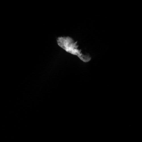Sunlight illuminates the bowling-pin shaped nucleus from directly below comet Borrelly as seen by NASA Deep Space 1. At this distance, many features become vivid on the surface of the nucleus, including a jagged line between day and night on the comet.