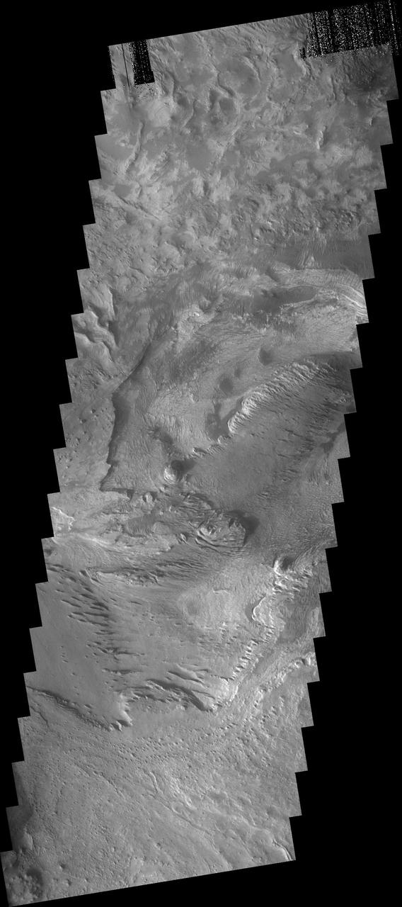 The layered and wind eroded deposits occur on the  floor of Chandor Chasma