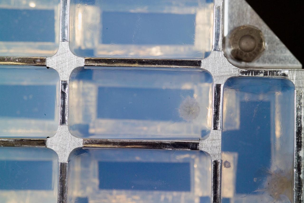 Closeup view of a cometary impact upper right into aerogel was inspected by scientists at a laboratory at the Johnson Space Center hours after NASA Stardust Sample Return Canister was delivered to the Johnson Space Center.