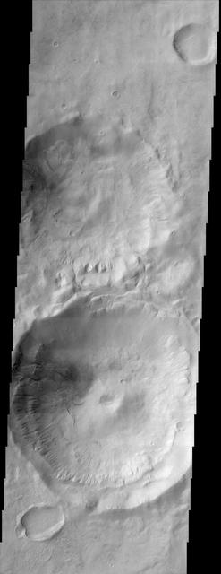 This scene shows gullies superposed on the inner walls of four large craters. Most of these gullies, imaged by NASA Mars Odyssey spacecraft, appear to emanate from one or two specific layers along the inner crater entire circumference.