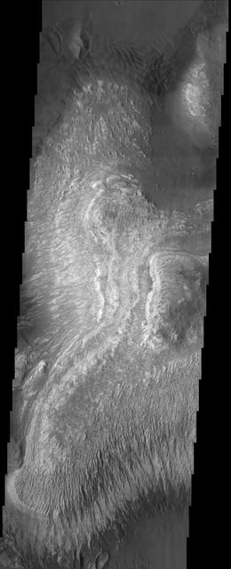 These layered deposits are located on the floor of a large canyon called Ganges Chasma which is a part of the Valles Marineris in this image captured by NASA 2001 Mars Odyssey spacecraft.