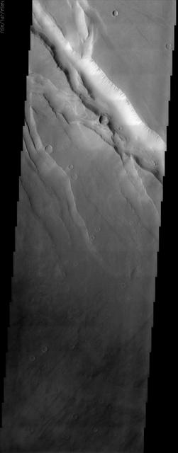 This NASA Mars Odyssey image covers a tract of plateau territory called Ophir Planum. The most obvious features in this scene are the fractures ranging from 1 to 5 km wide running from the upper left to lower right.