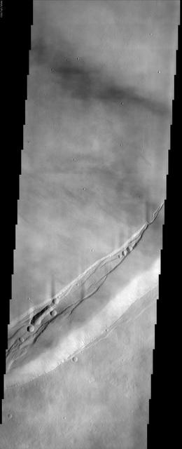 This NASA Mars Odyssey image shows a portion of the summit region of Arsia Mons, one of the four giant volcanoes in the Tharsis region of Mars. This volcano stands more than 20 km above the surrounding plains, and is about 450 km in diameter at its base.