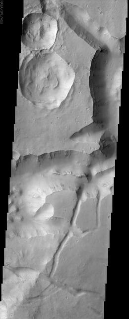 This image from NASA Mars Odyssey shows a portion of Aureum Chaos located just south of the Martian equator. This fractured landscape contains canyons and mesas with two large impact craters in the upper left.