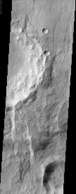 The eastern rim of this unnamed crater in Claritas Fossae is very degraded, as seen in this image from NASA Mars Odyssey, indicating that it very ancient and has been subjected to erosion and bombardment from impactors such as asteroids and comets.