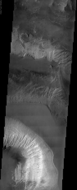 This NASA Mars Odyssey image shows the effects of erosion on a beautiful sequence of dramatically layered rocks within Candor Chasma, which is part of the Valles Marineris.