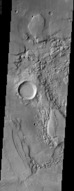 The jumbled, chaotic terrain in this NASA Mars Odyssey image may represent a source region for the Reull Vallis, one of the larger channel systems in the southern hemisphere of Mars.