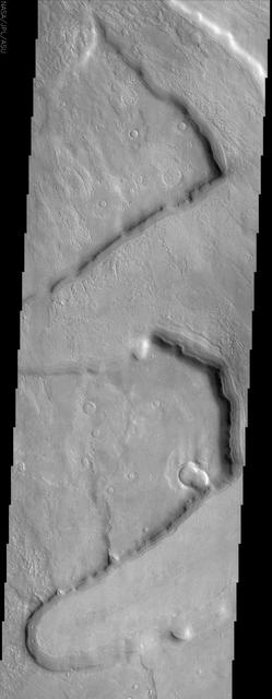 This NASA Mars Odyssey image shows several fretted channels within Deuteronilus Mensae in the northern plains of Mars. These linear troughs appear to have been extensively modified by surficial processes.