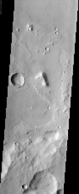 The floor of a 75 km diameter crater in the Amenthes region of Mars displays lobate flow features in the center of this image from NASA Mars Odyssey spacecraft. 