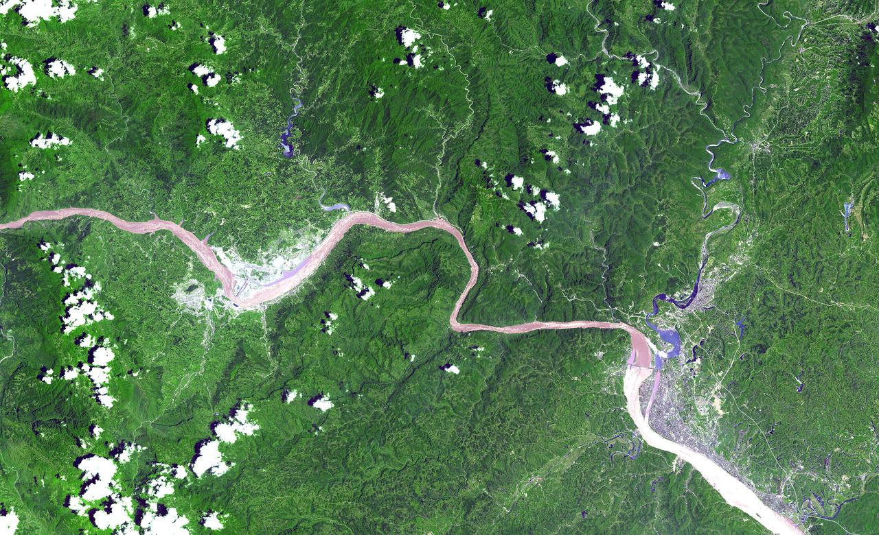 This ASTER image shows a 60 km stretch of the Yangtze River in China, including the Xiling Gorge, the eastern of the three gorges. In the left part of the image is the construction site of the Three Gorges Dam, the world's largest.  This image was acquired on July 20, 2000 by the Advanced Spaceborne Thermal Emission and Reflection Radiometer (ASTER) on NASA's Terra satellite. With its 14 spectral bands from the visible to the thermal infrared wavelength region, and its high spatial resolution of 15 to 90 meters (about 50 to 300 feet), ASTER will image Earth for the next 6 years to map and monitor the changing surface of our planet.  http://photojournal.jpl.nasa.gov/catalog/PIA03852