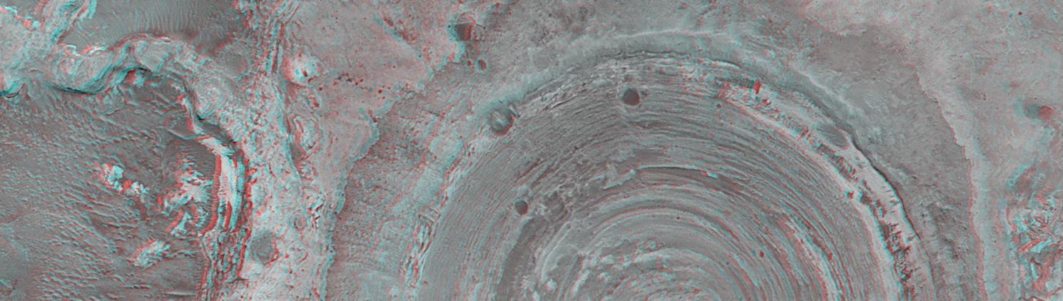 This anaglyph from NASA Mars Global Surveyor shows a circular feature in northern Terra Meridiani. The circular feature was once an impact crater. 3D glasses are necessary to view this image.