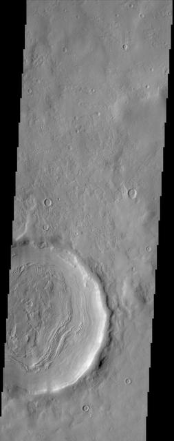 The layering of material observed at the bottom of this impact crater imaged by NASA Mars Odyssey spacecraft suggests multiple depositional and erosional episodes in a changing environment.  http://photojournal.jpl.nasa.gov/catalog/PIA04021