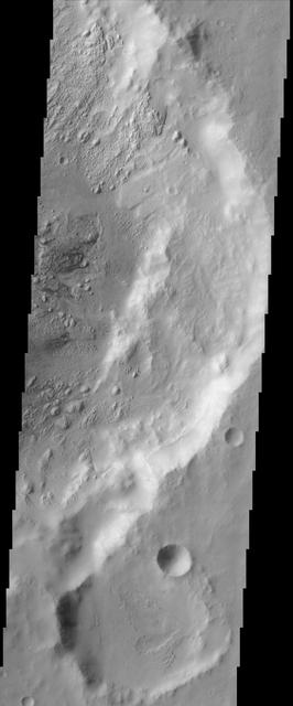 This image from NASA Mars Odyssey covers a region in western Arabia Terra, which contains two interesting craters. The eastern floor of the largest crater seen in most of this image is bumpy and ridged in places and relatively smooth in regions.