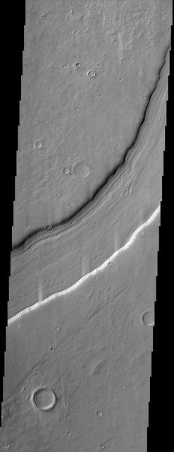 Reull Vallis, located in Mars cratered southern hemisphere, flows for over 1,000 km about 620 miles toward the Hellas basin. This NASA Mars Odyssey image shows a portion of the channel with its enigmatic lineated floor deposits.