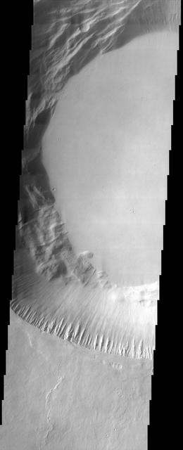 This image from NASA Mars Odyssey shows part of the summit caldera of Pavonis Mons, the middle of three Tharsis volcanos that form a line southeast of Olympus Mons and northwest of Vallis Marineris.