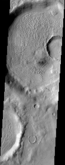 The floors of these craters imaged by NASA Mars Odyssey contain very interesting and enigmatic materials that may hold shallow subsurface ground ice with varying amounts of a sediment covering mantle.