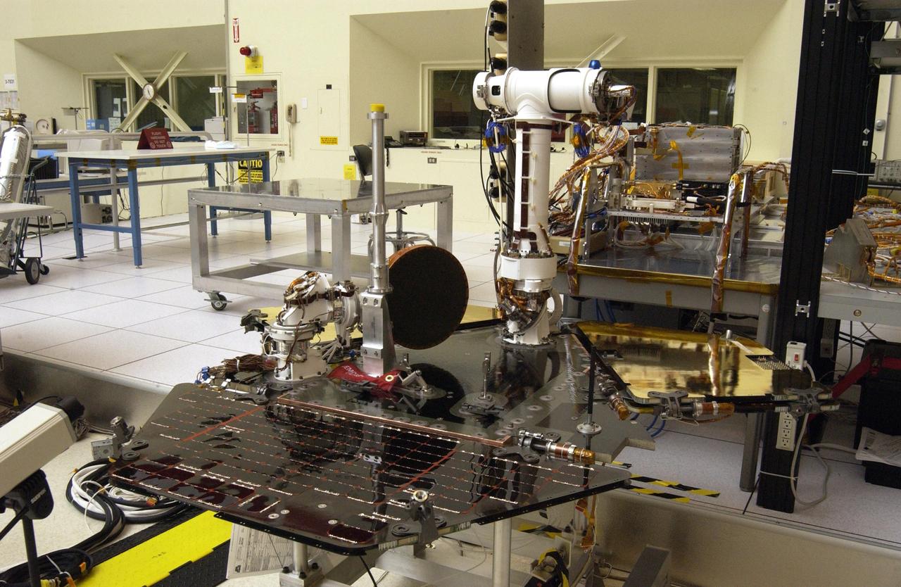 NASA Rover 2 equipment deck, with solar arrays partially deployed, in NASA JPL Spacecraft Assembly Facility cleanroom.