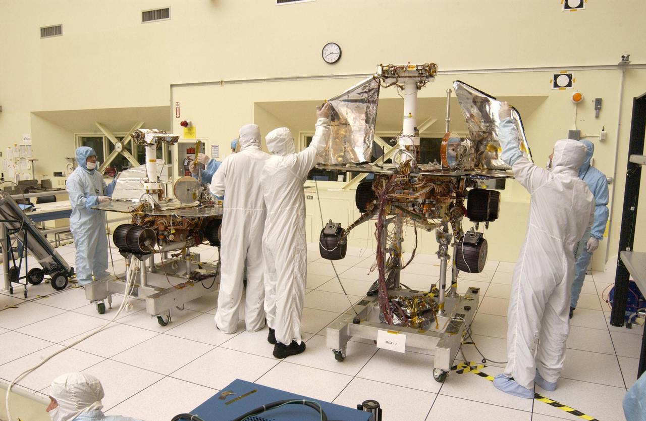 JPL engineers hand-deploying the solar arrays that provide the electrical power on NASA Mars Exploration Rover 1.