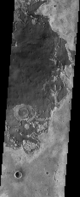 The remarkable terrain at the center of Mars 0 degrees latitude and longitude, as seen in this NASA Mars Odyssey image, is called Meridiani Planum. It hosts a rare occurrence of gray crystalline hematite.