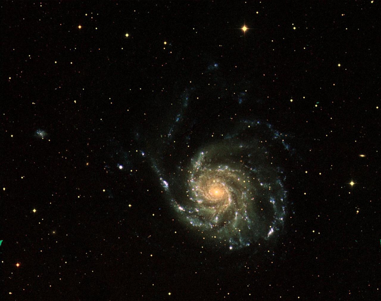 This three-color image of galaxy M101 was taken by NASA's Galaxy Evolution Explorer on June 20, 2003. The far ultraviolet emissions are shown in blue, the near ultraviolet emissions are green, and the red emissions, which were taken from NASA's Digital Sky Survey, represent visible light. This image combines short, medium, and long "exposure" pictures to best display the evolution of star formation in a spiral galaxy.  http://photojournal.jpl.nasa.gov/catalog/PIA04630