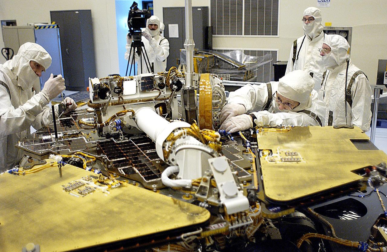 In the Payload Hazardous Servicing Facility, technicians remove one of the circuit boards on the Mars Exploration Rover 2 MER-2.