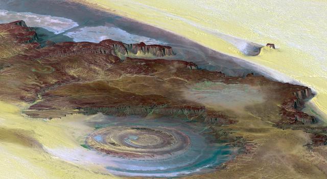 This prominent circular feature, known as the Richat Structure, in the Sahara desert of Mauritania is often noted by astronauts because it forms a conspicuous bull-eye on the otherwise rather featureless expanse of the desert.