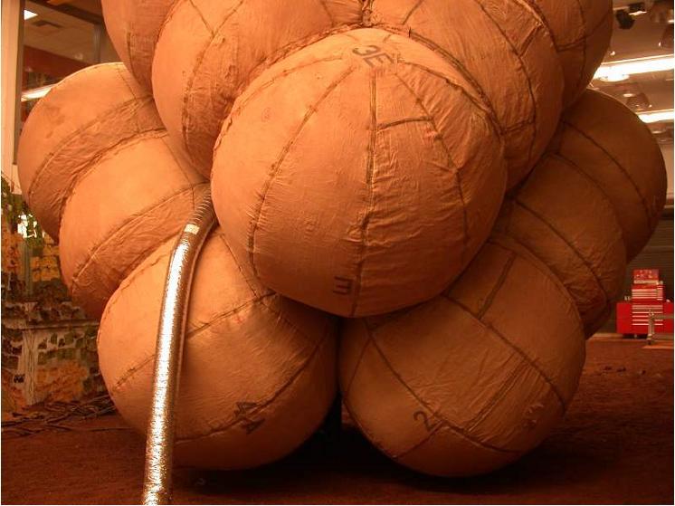 Airbags are fully inflated in this photograph taken at the JPL In-Situ Instrument Laboratory or Testbed, where engineers simulated the orientation of the airbags during the deflation process.