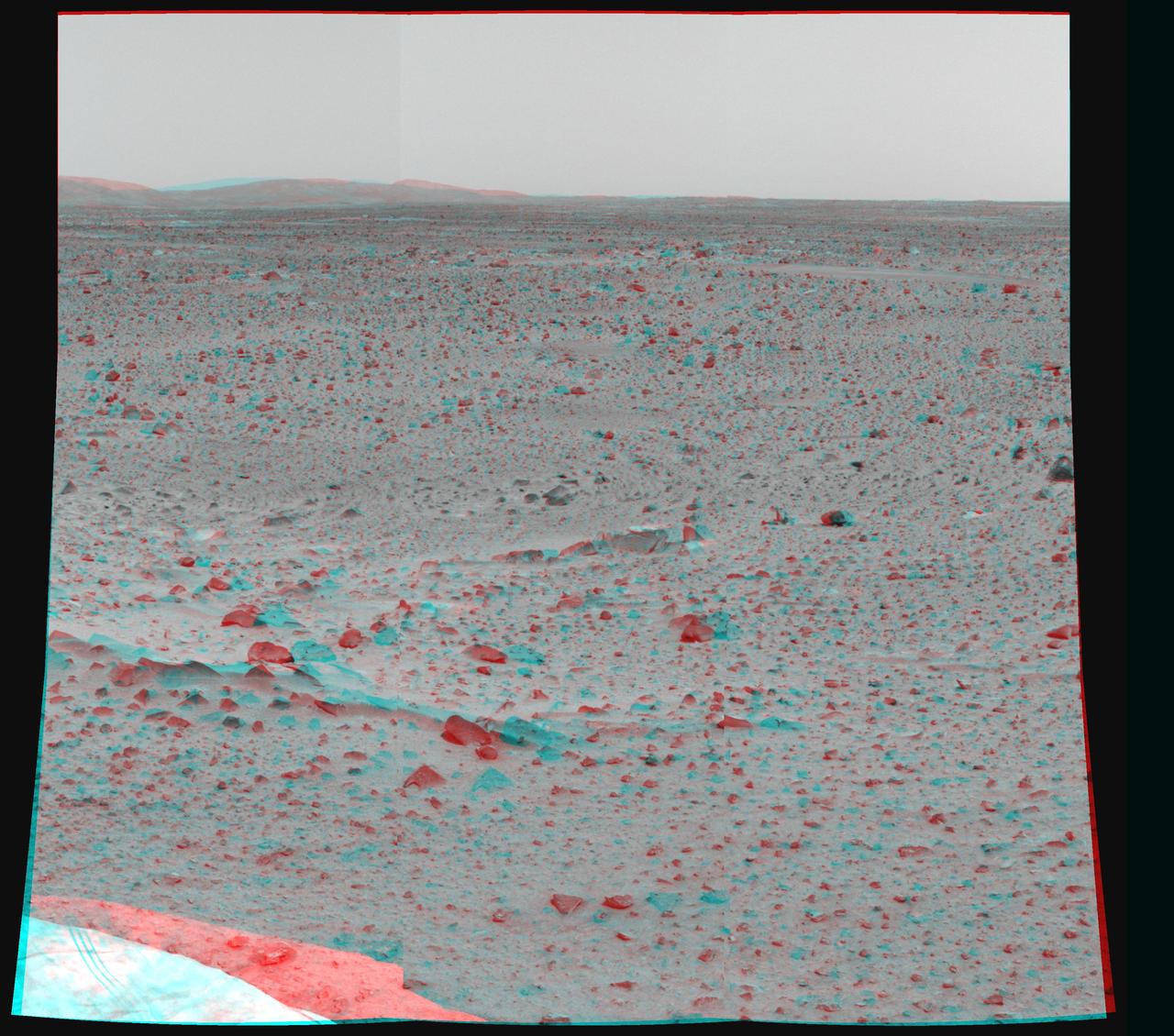 Martian terrain is seen in this 3-D image taken by the panoramic camera on NASA Mars Exploration Rover Spirit. 3D glasses are necessary to view this image.