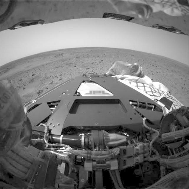 This frame from an animation flips back and forth between images taken before and after deployment of the Mars Exploration Rover Spirit's bogie, a part of the rover's suspension system that extends the wheel base. These images were taken by Spirit's hazard avoidance camera.  An animation is available at http://photojournal.jpl.nasa.gov/catalog/PIA05040