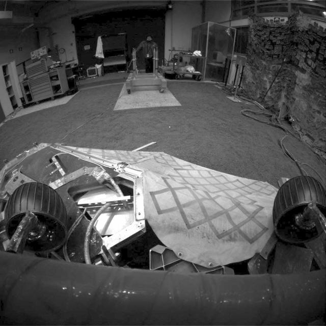 This image shows a test rover in a near-final turned position on the lander in NASA Jet Propulsion Laboratory In-Situ Instruments Laboratory, or testbed.
