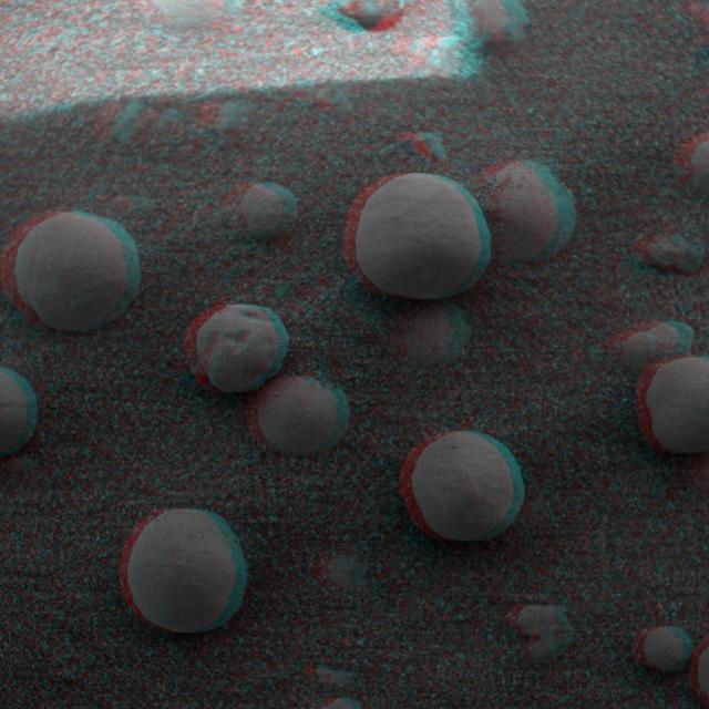 This is 3-D anaglyph, from NASA Mars Exploration Rover Spirit, shows an extreme close-up of round, blueberry-shaped grains on the crater floor near the rock outcrop at Meridiani Planum called Stone Mountain. 3D glasses are necessary.