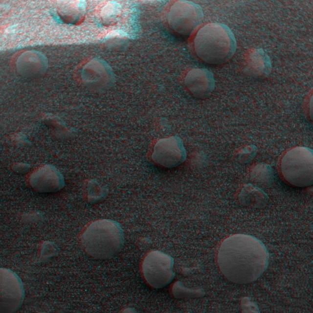 This 3-D anaglyph, from NASA Mars Exploration Rover Spirit, shows an extreme close-up of round, blueberry-shaped grains on the crater floor near the rock outcrop at Meridiani Planum called Stone Mountain. 3D glasses are necessary.