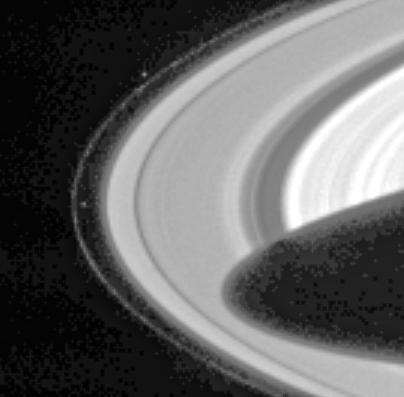 Cassini has sighted Prometheus and Pandora, the two F-ring-shepherding moons whose unpredictable orbits both fascinate scientists and wreak havoc on the F ring.  Prometheus (102 kilometers, or 63 miles across) is visible left of center in the image, inside the F ring. Pandora (84 kilometers, or 52 miles across) appears above center, outside the ring. The dark shadow cast by the planet stretches more than halfway across the A ring, the outermost main ring. The mottled pattern appearing in the dark regions of the image is 'noise' in the signal recorded by the camera system, which has subsequently been magnified by the image processing.  The F ring is a narrow, ribbon-like structure, with a width seen in this geometry equivalent to a few kilometers. The two small, irregularly shaped moons exert a gravitational influence on particles that make up the F ring, confining it and possibly leading to the formation of clumps, strands and other structures observed there. Pandora prevents the F ring from spreading outward and Prometheus prevents it from spreading inward. However, their interaction with the ring is complex and not fully understood. The shepherds are also known to be responsible for many of the observed structures in Saturn's A ring.  The moons, which were discovered in images returned by the Voyager 1 spacecraft in 1980, are in chaotic orbits--their orbits can change unpredictably when the moons get very close to each other. This strange behavior was first noticed in ground-based and Hubble Space Telescope observations in 1995, when the rings were seen nearly edge-on from Earth and the usual glare of the rings was reduced, making the satellites more readily visible than usual. The positions of both satellites at that time were different than expected based on Voyager data.  One of the goals for the Cassini-Huygens mission is to derive more precise orbits for Prometheus and Pandora. Seeing how their orbits change over the duration of the mission will help to determine their masses, which in turn will help constrain models of their interiors and provide a more complete understanding of their effect on the rings.  This narrow angle camera image was snapped through the broadband green spectral filter, centered at 568 nanometers, on March 10, 2004, when the spacecraft was 55.5 million kilometers (34.5 million miles) from the planet. Image scale is approximately 333 kilometers (207 miles) per pixel. Contrast has been greatly enhanced, and the image has been magnified to aid visibility of the moons as well as structure in the rings.  http://photojournal.jpl.nasa.gov/catalog/PIA05387