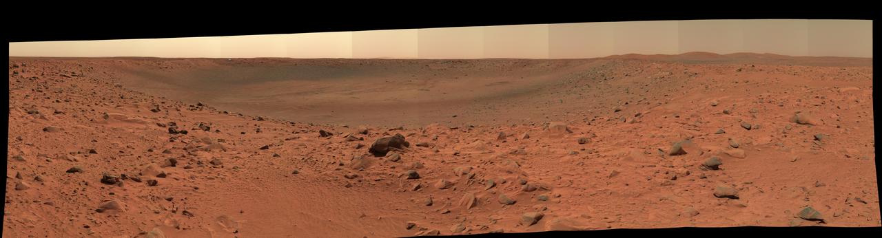 The rim and interior of a crater nicknamed "Bonneville" dominate this 180-degree, false-color mosaic of images taken by the panoramic camera of NASA's Mars Exploration Rover Spirit. Spirit recorded this view on the rover's 68th sol, March 12, 2004, one sol after reaching this location. The rover remaining here in part to get this very high-resolution, color mosaic, from which scientists can gain insight about the depth of the surface material at Bonneville and make future observation plans. On sol 71, Spirit was instructed to drive approximately 15 meters (49 feet) along the crater rim to a new vantage point. The image is a false-color composite made from frames taken with the camera's L2, L5 and L6 filters. http://photojournal.jpl.nasa.gov/catalog/PIA05570