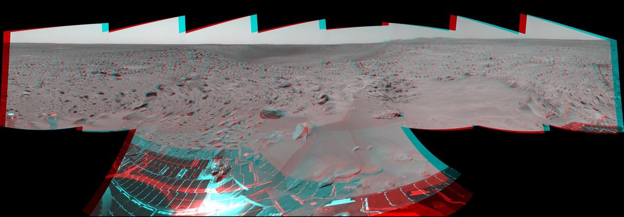 NASA Mars Exploration Rover Spirit took this 3-D navigation camera mosaic of the crater called Bonneville. The rover solar panels can be seen in the foreground. 3D glasses are necessary to view this image.
