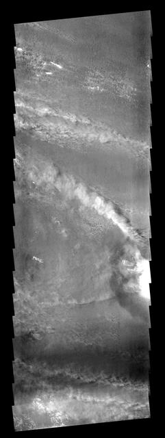 The crater on the right side of this image is affecting the local wind  regime. Note the bright line of clouds streaming off the north rim of the  crater