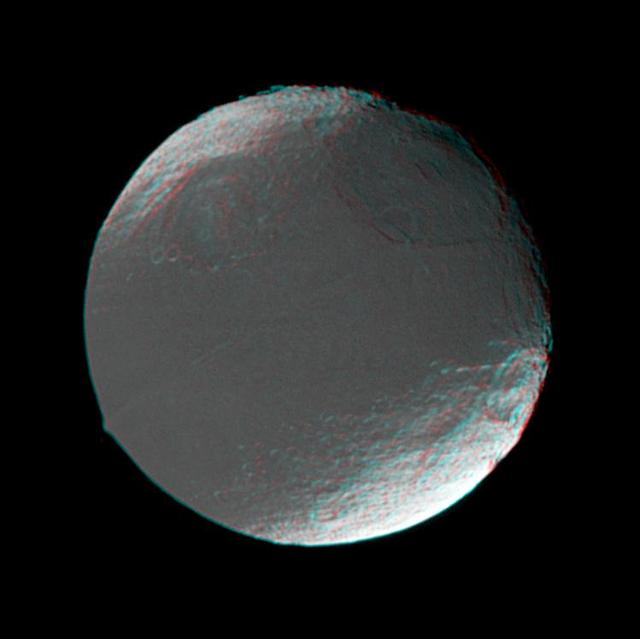 This stereo view of Iapetus was created by combining two NASA Cassini images, which were taken one day apart. The view serves mainly to show the spherical shape of Iapetus and some of the moon’s topography. 3D glasses are necessary to view this image.