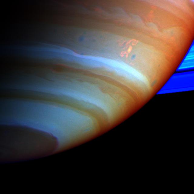 A large, bright and complex convective storm that appeared in Saturn's southern hemisphere in mid-September 2004 was the key in solving a long-standing mystery about the ringed planet. Saturn's atmosphere and its rings are shown here in a false color composite made from Cassini images taken in near infrared light through filters that sense different amounts of methane gas. Portions of the atmosphere with a large abundance of methane above the clouds are red, indicating clouds that are deep in the atmosphere. Grey indicates high clouds, and brown indicates clouds at intermediate altitudes. The rings are bright blue because there is no methane gas between the ring particles and the camera. The complex feature with arms and secondary extensions just above and to the right of center is called the Dragon Storm. It lies in a region of the southern hemisphere referred to as "storm alley" by imaging scientists because of the high level of storm activity observed there by Cassini in the last year. The Dragon Storm was a powerful source of radio emissions during July and September of 2004. The radio waves from the storm resemble the short bursts of static generated by lightning on Earth. Cassini detected the bursts only when the storm was rising over the horizon on the night side of the planet as seen from the spacecraft; the bursts stopped when the storm moved into sunlight. This on/off pattern repeated for many Saturn rotations over a period of several weeks, and it was the clock-like repeatability that indicated the storm and the radio bursts are related. Scientists have concluded that the Dragon Storm is a giant thunderstorm whose precipitation generates electricity as it does on Earth. The storm may be deriving its energy from Saturn's deep atmosphere. One mystery is why the radio bursts start while the Dragon Storm is below the horizon on the night side and end when the storm is on the day side, still in full view of the Cassini spacecraft. A possible explanation is that the lightning source lies to the east of the visible cloud, perhaps because it is deeper where the currents are eastward relative to those at cloud top levels. If this were the case, the lightning source would come up over the night side horizon and would sink down below the day side horizon before the visible cloud. This would explain the timing of the visible storm relative to the radio bursts. The Dragon Storm is of great interest for another reason. In examining images taken of Saturn's atmosphere over many months, imaging scientists found that the Dragon Storm arose in the same part of Saturn's atmosphere that had earlier produced large bright convective storms. In other words, the Dragon Storm appears to be a long-lived storm deep in the atmosphere that periodically flares up to produce dramatic bright white plumes which subside over time. One earlier sighting, in July 2004, was also associated with strong radio bursts. And another, observed in March 2004 and captured in a movie created from images of the atmosphere (PIA06082 and PIA06083) spawned three little dark oval storms that broke off from the arms of the main storm. Two of these subsequently merged with each other; the current to the north carried the third one off to the west, and Cassini lost track of it. Small dark storms like these generally get stretched out until they merge with the opposing currents to the north and south. These little storms are the food that sustains the larger atmospheric features, including the larger ovals and the eastward and westward currents. If the little storms come from the giant thunderstorms, then together they form a food chain that harvests the energy of the deep atmosphere and helps maintain the powerful currents. Cassini has many more chances to observe future flare-ups of the Dragon Storm, and others like it over the course of the mission. It is likely that scientists will come to solve the mystery of the radio bursts and observe storm creation and merging in the next 2 or 3 years. http://photojournal.jpl.nasa.gov/catalog/PIA06197
