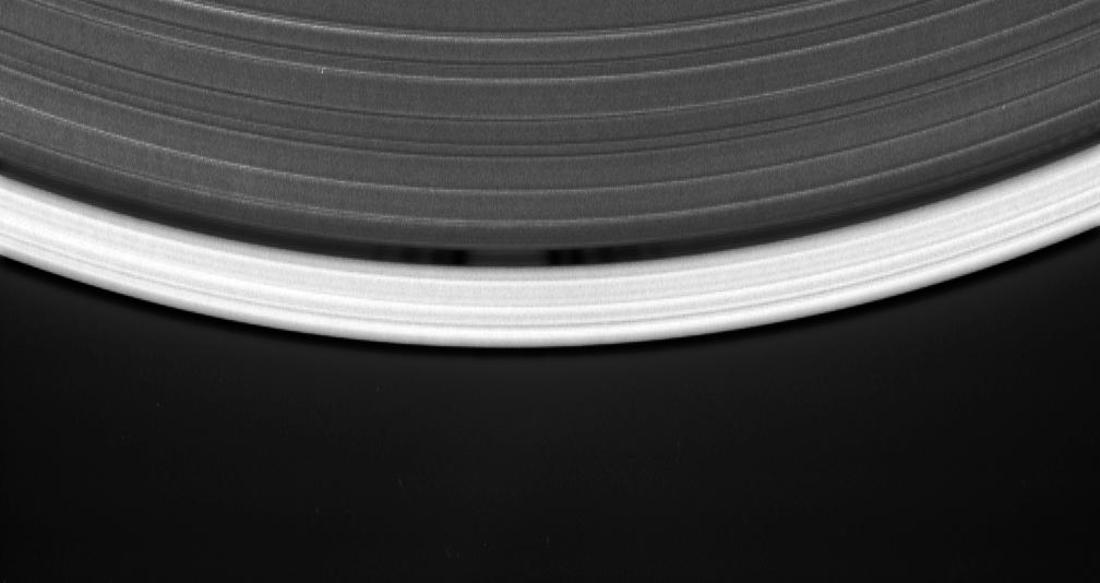 Cassini's celestial sleuthing has paid off with this time-lapse series of images which confirmed earlier suspicions that a small moon was orbiting within the narrow Keeler gap of Saturn's rings.  The movie sequence, which consists of 12 images taken over 16 minutes while Cassini gazed down upon the sunlit side of the A ring, shows a tiny moon orbiting in the center of the Keeler gap, churning up waves in the gap edges as it goes. The pattern of waves travels with the moon in its orbit.  The Keeler gap is located about 250 kilometers (155 miles) inside the outer edge of the A ring, which is also the outer edge of the bright main rings. The new object is about 7 kilometers across (4 miles) and reflects about 50 percent of the sunlight that falls upon it -- a brightness that is typical of particles in the nearby rings.  The new body has been provisionally named S/2005 S1.  Imaging scientists predicted the moon's presence and its orbital distance from Saturn after July 2004, when they saw a set of peculiar spiky and wispy features in the Keeler gap's outer edge. The similarities of the Keeler gap features to those noted in Saturn's F ring and the Encke gap led the scientists to conclude that a small body, a few kilometers across, was lurking in the center of the Keeler gap, awaiting discovery.  Also included here is a view of the same scene created by combining six individual, unmagnified frames used in the movie sequence. This digital composite view improves the overall resolution of the scene compared to that available in any of the single images.  The images in this movie sequence were obtained with the Cassini spacecraft narrow-angle camera on May 1, 2005, at a distance of approximately 1.1 million kilometers (708,000 miles) from Saturn. Resolution in the original image was 8 kilometers (5 miles) per pixel. The images in the movie sequence have been magnified in (the vertical direction only) by a factor of two to aid visibility of features caused within the gap by the moonlet.  An animation is available at http://photojournal.jpl.nasa.gov/catalog/PIA06238
