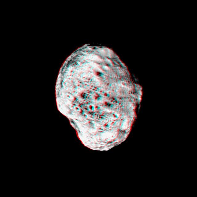 Saturn moon Hyperion pops into view in this stereo anaglyph created from NASA Cassini images; differing views are helpful in interpreting the moon irregular shape. 3D glasses are necessary to view this image.