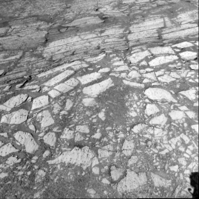 This view of rock layers exposed in the upper portion of the inner slope of "Endurance Crater" was captured by the navigation camera on NASA's Mars Exploration Rover Opportunity from the rover's position inside the crater during Opportunity's 134th sol on June 9, 2004. Scientists and engineers are assessing possible targets and routes among these rocks. The view is looking down into the crater, so the layers at the top of the image lie lower in the crater than the rocks in the foreground. http://photojournal.jpl.nasa.gov/catalog/PIA06263