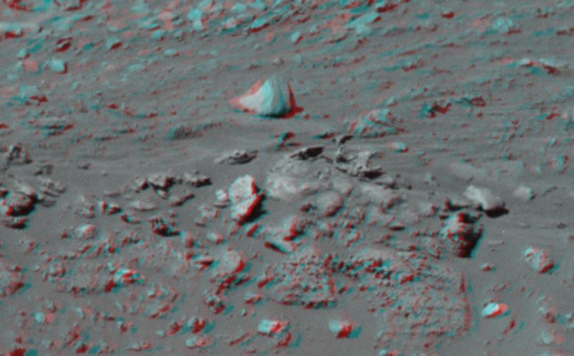 This 3-D image taken by the left and right eyes of the panoramic camera on NASA Mars Exploration Rover Spirit shows the odd rock formation dubbed Cobra Hoods center. 3D glasses are necessary to view this image.