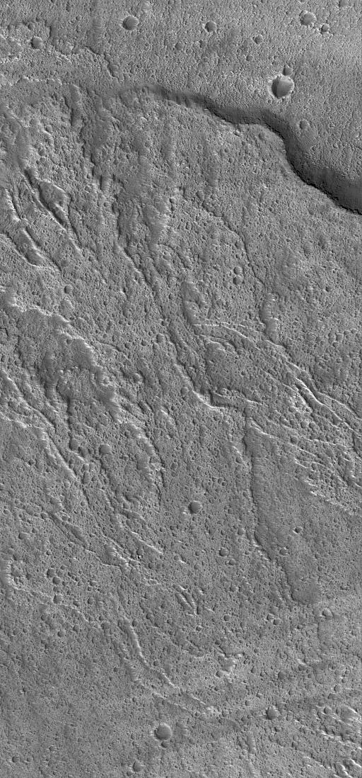 This Mars Global Surveyor (MGS) Mars Orbiter Camera (MOC) image shows lava flows on the middle west flank of the large martian volcano, Ascraeus Mons. The flows ran downslope from the lower right (southeast) toward upper left (northwest). These flows are located near 11.9°N, 105.5°W. This December 2003 image covers an area about 3 km (1.9 mi) across; sunlight illuminates the scene from the lower left.  http://photojournal.jpl.nasa.gov/catalog/PIA06288