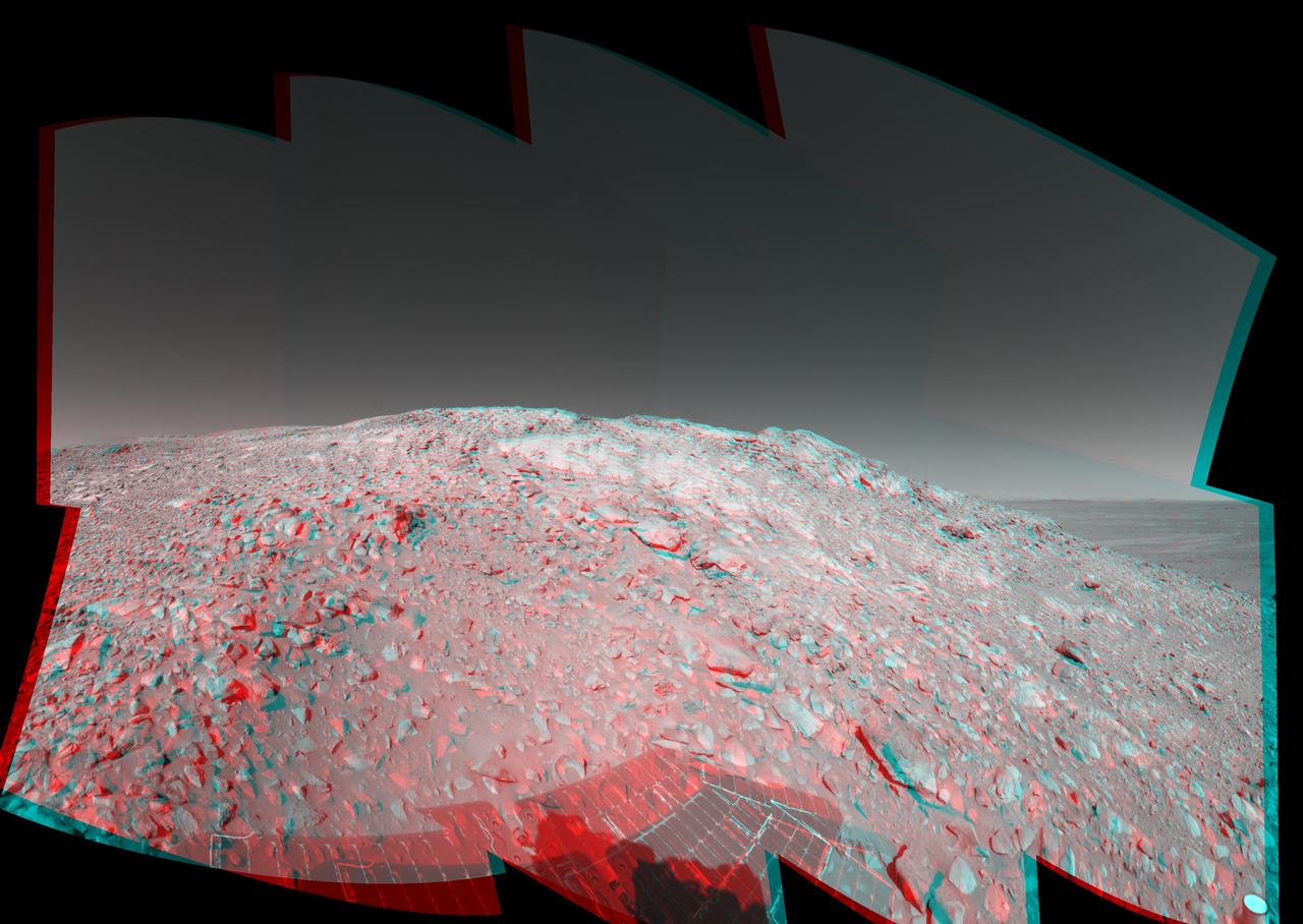 In this stereo image, a rock outcrop with a view of the surrounding landscape beckons NASA Mars Exploration Rover Spirit on sol 203. 3D glasses are necessary to view this image.