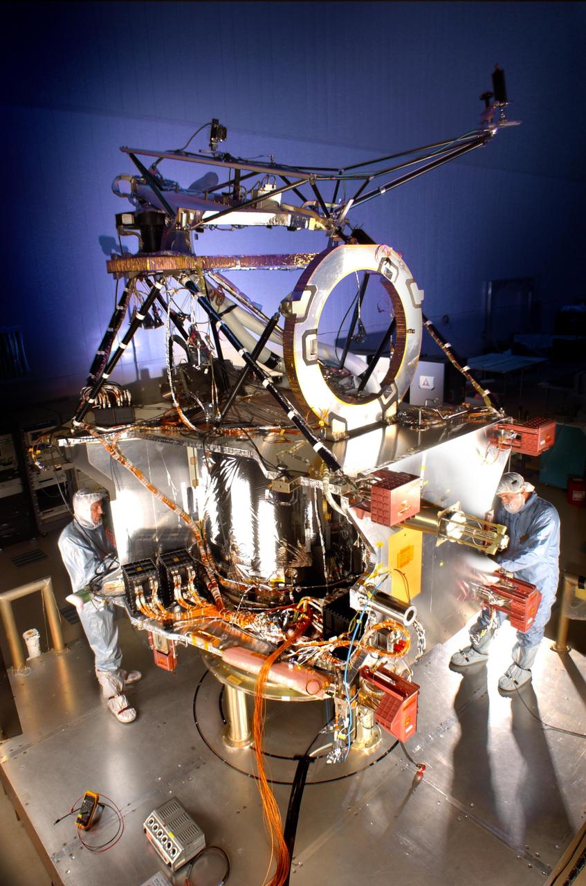 Lockheed Martin Space Systems engineer Terry Kampmann left and lead technician Jack Farmerie work on assembly and test of NASA Mars Reconnaissance Orbiter spacecraft bus in a cleanroom at the company Denver facility.